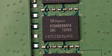 Detailed view of SK hynix DRAM chips on a green circuit board featuring electronic components.