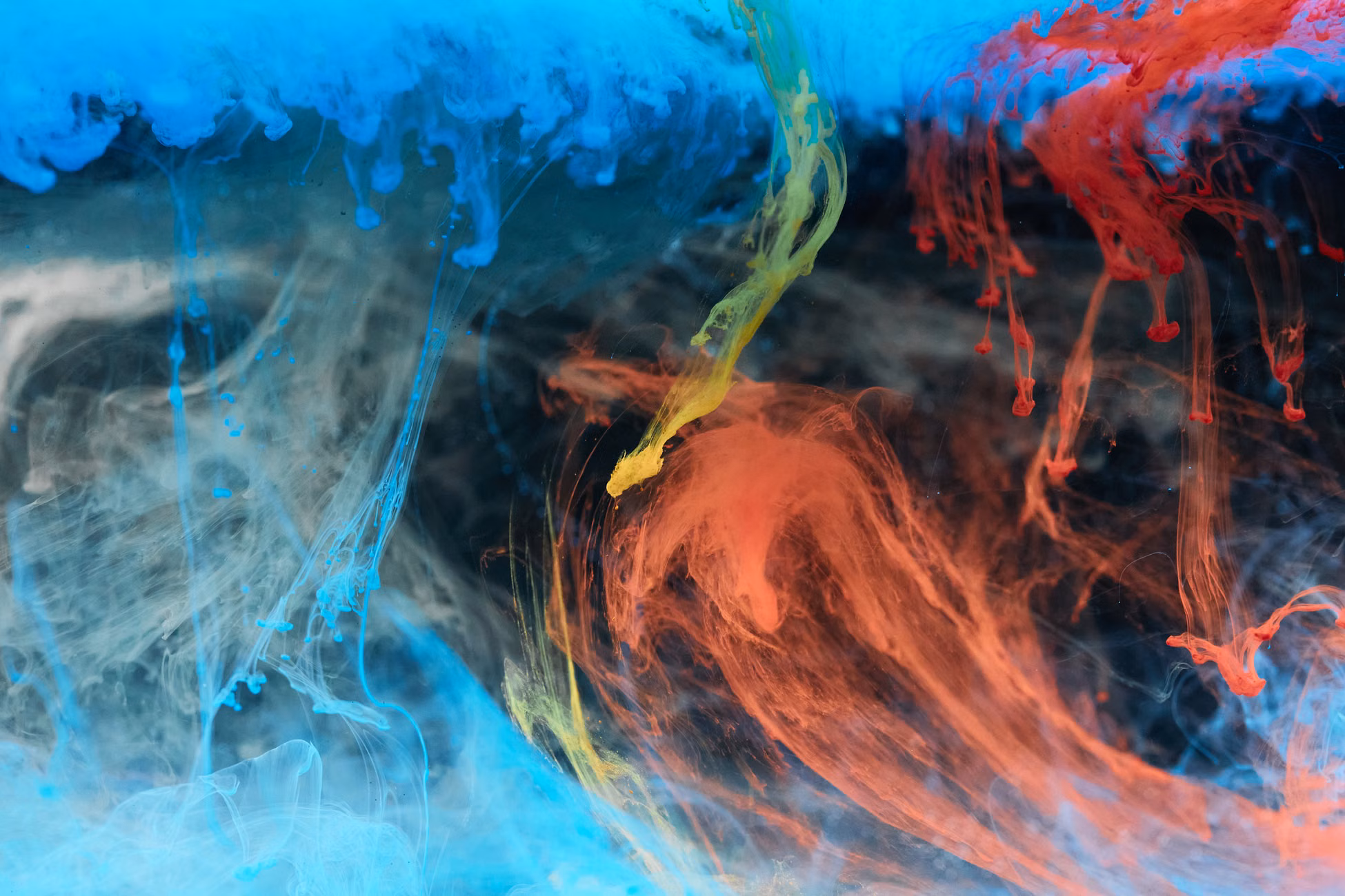 A dynamic display of colorful ink swirling in water, showcasing vibrant hues and artistic textures.