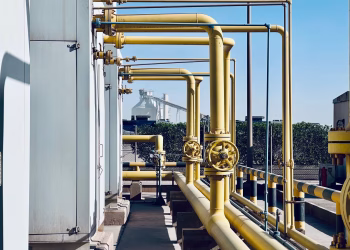 A detailed view of industrial pipelines in a Saudi Arabian factory setting.