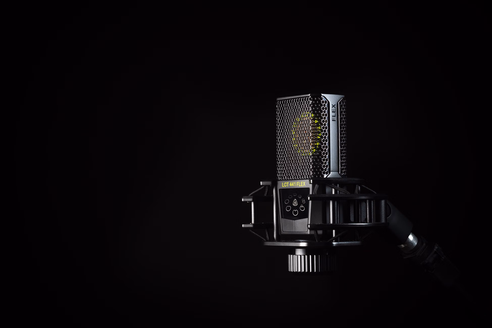 A detailed studio shot of a condenser microphone against a black background, emphasizing modern audio technology.