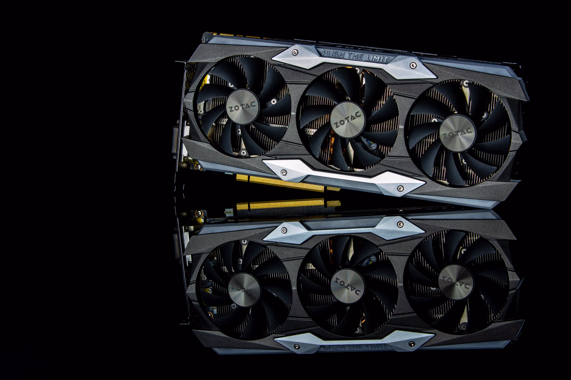 Close-up photo of a modern graphics card with cooling fans on a black background.