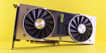 Close-up of a RTX 2080 Super graphics card against a bright yellow backdrop, showcasing high-tech design.