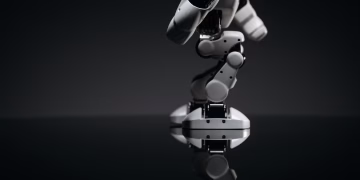 A close-up image of a mechanical robotic arm reflecting on a dark surface, capturing industrial innovation.