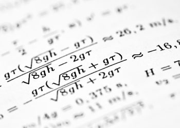 Mathematical formulas are shown on the paper.