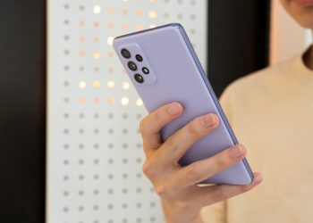person holding white and blue iphone case