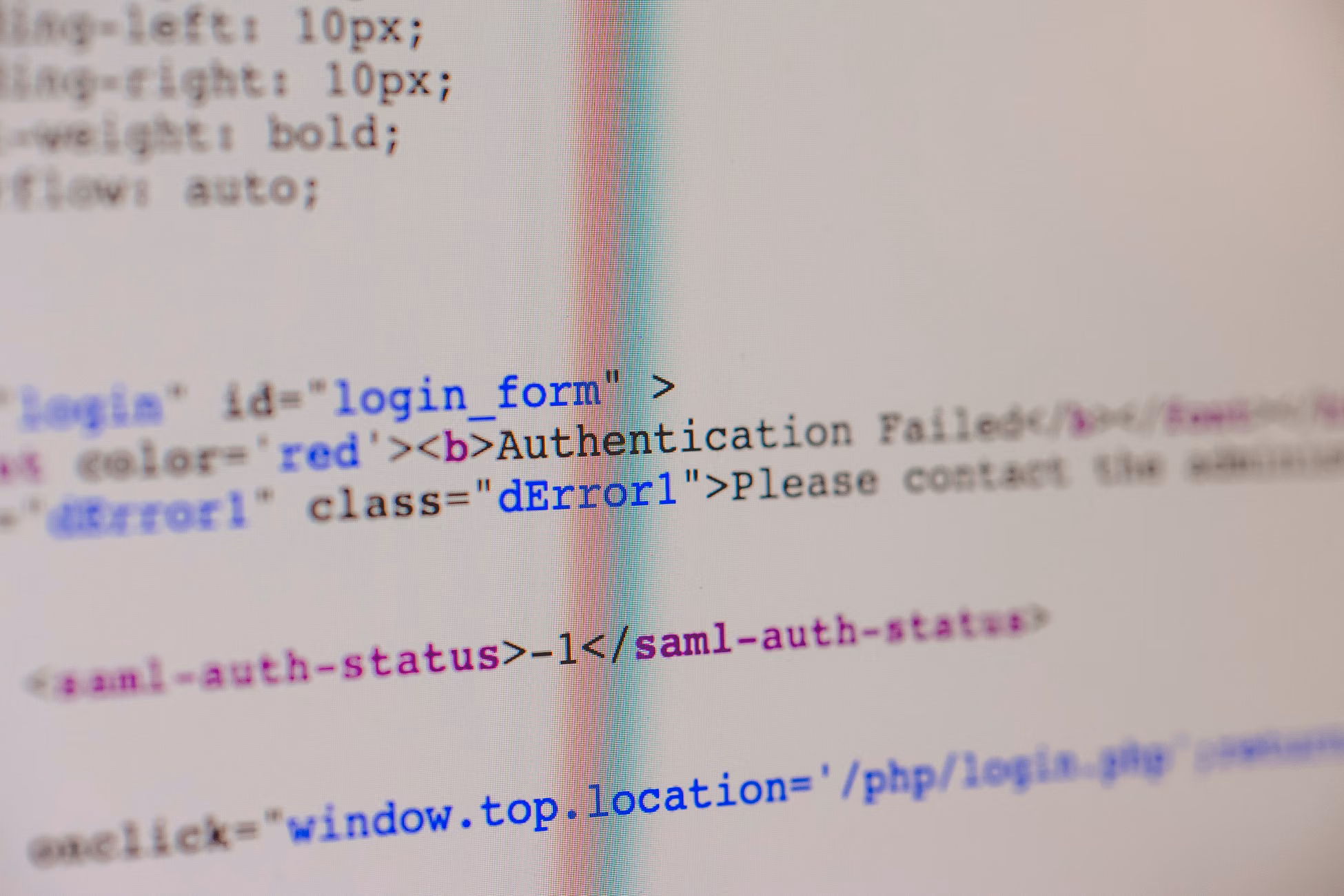 Close-up of HTML and PHP code on screen showing error message and login form data.