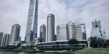 Modern skyscrapers of Shenzhen skyline by the waterfront on a cloudy day.