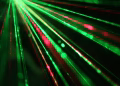Dynamic display of red and green laser beams creating an abstract and vibrant visual effect.