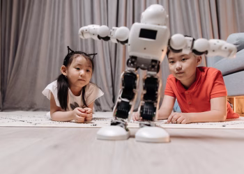Children enjoying playtime with a modern android robot on a rug indoors.