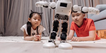 Children enjoying playtime with a modern android robot on a rug indoors.
