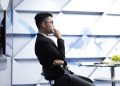 man in black long sleeve shirt sitting on black chair
