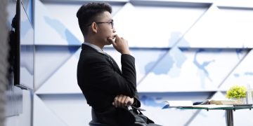 man in black long sleeve shirt sitting on black chair