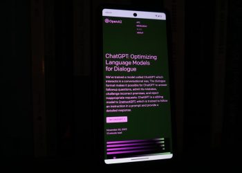 a cell phone with a lit up screen in the dark