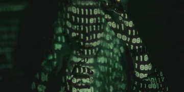 An unrecognizable person with binary code projected, symbolizing cybersecurity and digital coding.
