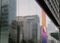 A city's reflection in a modern glass building facade capturing urban architecture and corporate design.