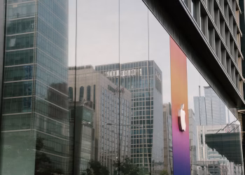 A city's reflection in a modern glass building facade capturing urban architecture and corporate design.