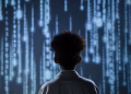A young boy viewing a digital screen with data streams, symbolizing technology interaction.