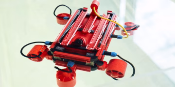 Robot made with 3d printer with cables and wires against white background