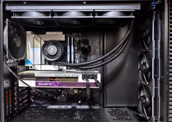 Interior view of a gaming PC showcasing a GeForce RTX graphics card and high-performance cooling system.