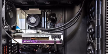 Interior view of a gaming PC showcasing a GeForce RTX graphics card and high-performance cooling system.