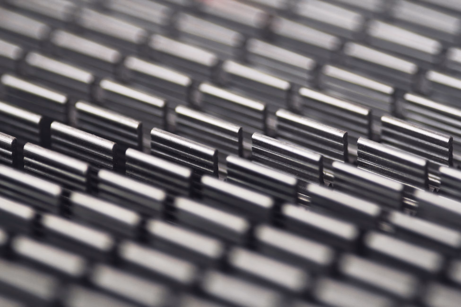 Close-up abstract photo of a metallic patterned surface with selective focus.