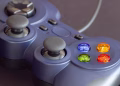 Detailed close-up of a gaming controller emphasizing its vibrant buttons.