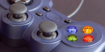 Detailed close-up of a gaming controller emphasizing its vibrant buttons.