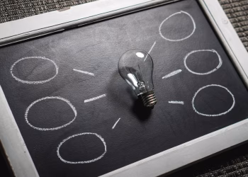 Chalkboard with a light bulb symbolizing ideas and creativity. Perfect for education themes.