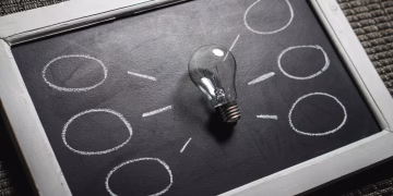 Chalkboard with a light bulb symbolizing ideas and creativity. Perfect for education themes.