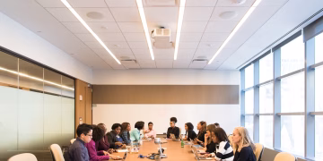 A multicultural team brainstorming and collaborating during a business meeting.