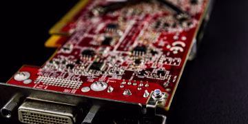 Detailed close-up of a red circuit board showcasing electronic components.