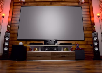 Stylish home theater featuring large screen, audio system, and decor, perfect for entertainment.