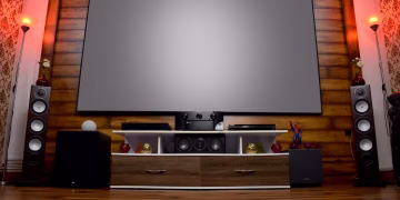 Stylish home theater featuring large screen, audio system, and decor, perfect for entertainment.