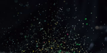 Vibrant multicolor paint splatter captured in motion with a dark backdrop, ideal for creative design.