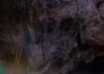 Abstract image of swirling smoke patterns against a dark background, creating a mysterious texture.
