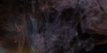 Abstract image of swirling smoke patterns against a dark background, creating a mysterious texture.