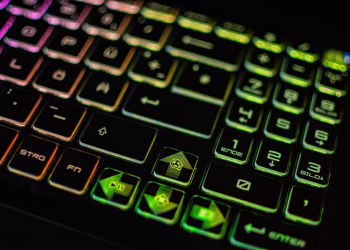 High-resolution image of a colorful backlit gaming keyboard with various symbols and numbers.