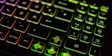 High-resolution image of a colorful backlit gaming keyboard with various symbols and numbers.