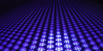 A captivating abstract image featuring glowing purple spheres in a dynamic pattern.