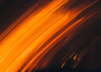 Vivid abstract light streaks creating a dynamic and energetic composition with warm tones.
