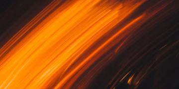 Vivid abstract light streaks creating a dynamic and energetic composition with warm tones.