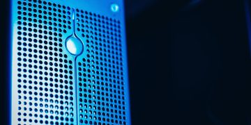 Modern server rack with blue lighting in a secure data center environment.